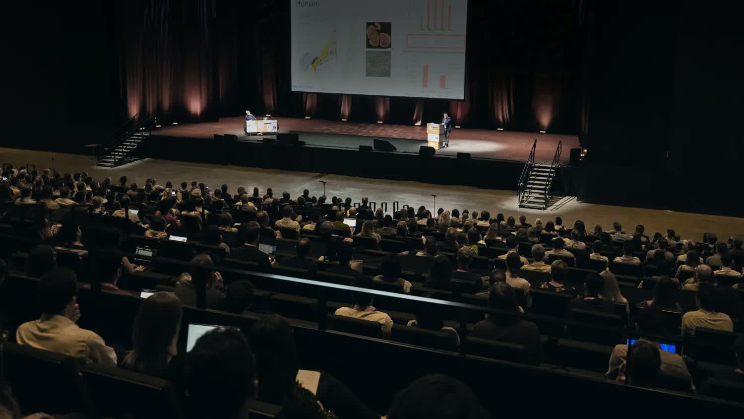 Delegates seated in a full auditorium during a plenary session at an international medical congress